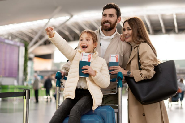 Happy family at the airport, ready for their trip with passports and luggage.