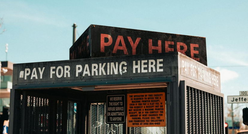 Structure with signs indicating payment for parking, emphasizing the need to pay for parking services.