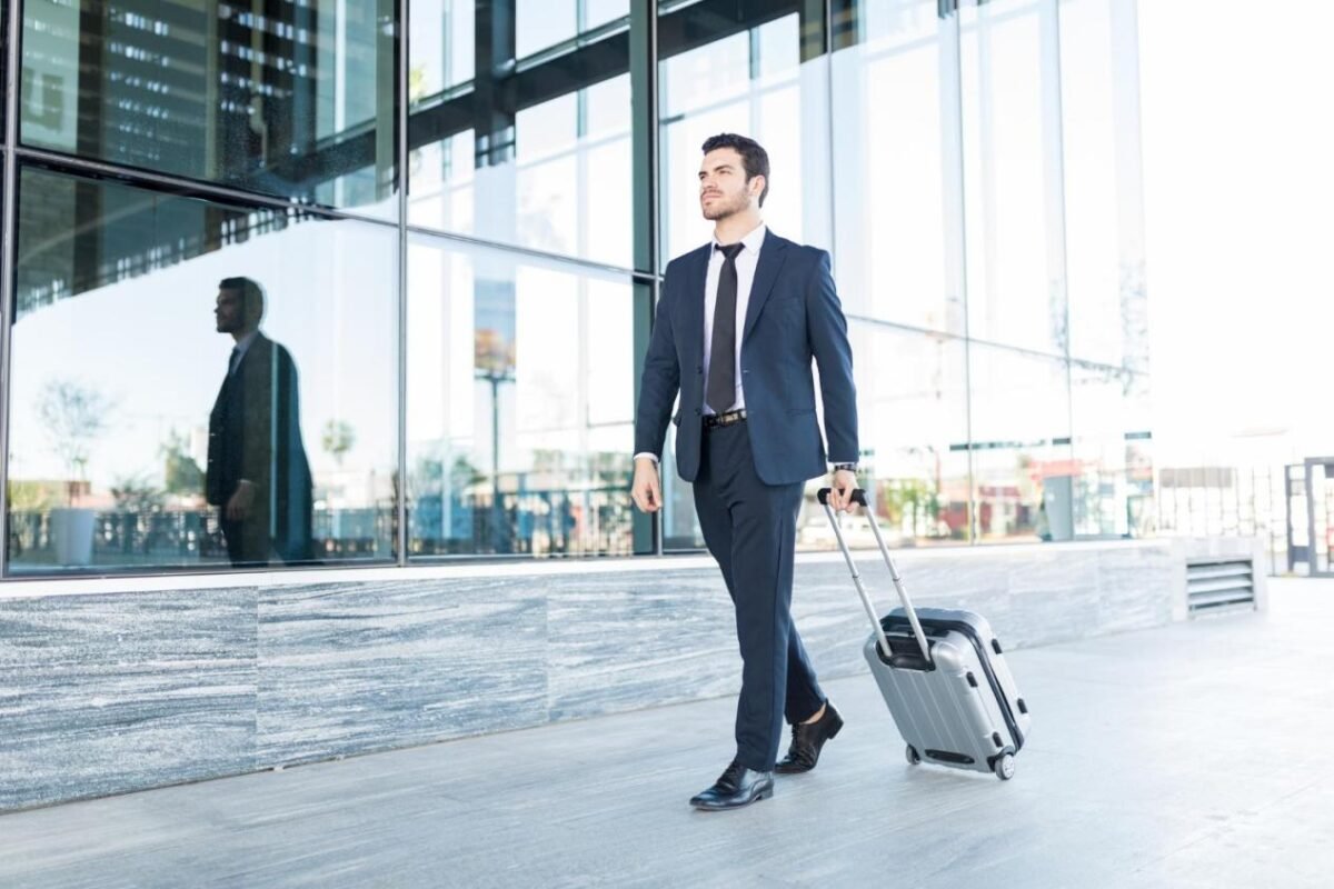 Businessman walking with a suitcase at airport.